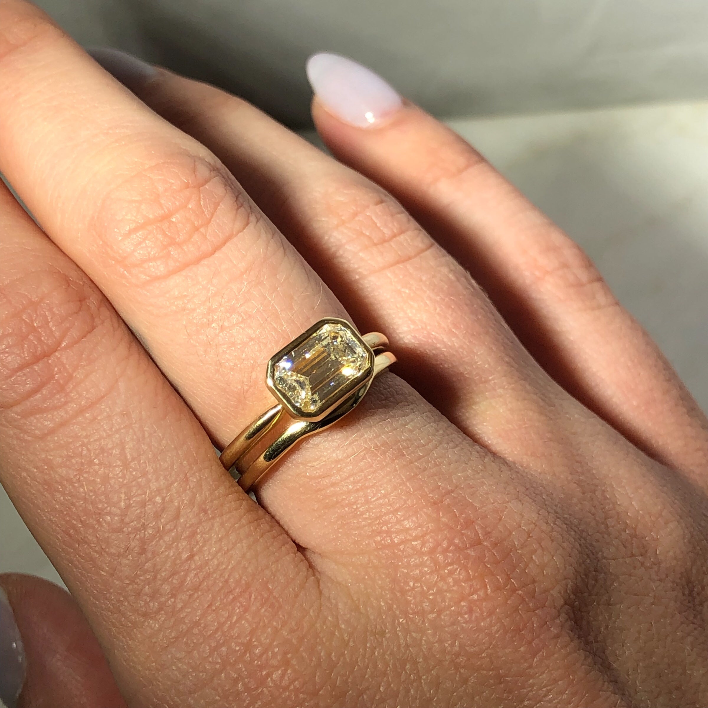 East West Bezel Set Emerald Cut Engagement Ring