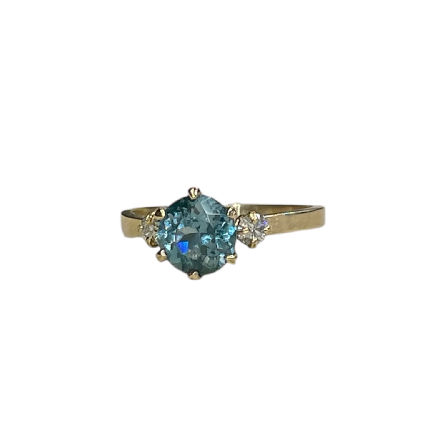 Seafoam sapphire engagement ring with diamond trillion side stones on a 14k yellow gold band featuring a six prong setting