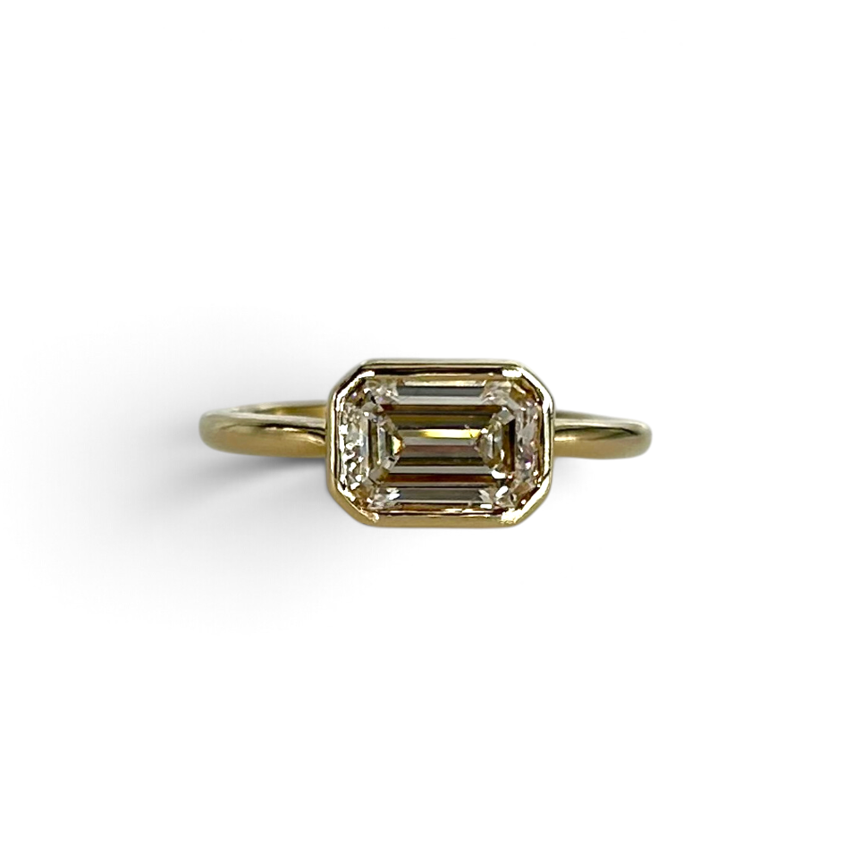 The East-West Bezel Emerald Cut Engagement Ring
